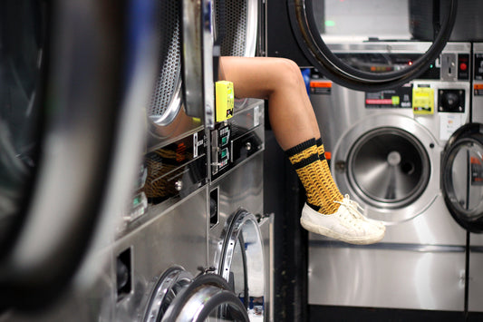 mustard socks girl legs laundrette laundromat photography hot gold knit socks unique byron bay nsw australia style lifestyle mannie brand socks colourful socks
